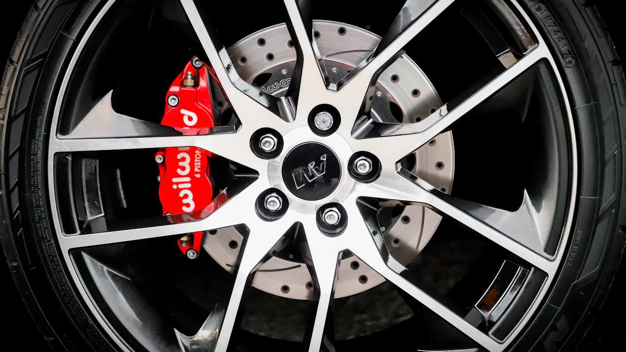 A close-up of an alloy wheel and tyre on a parked car, the spokes and sidewall filling the frame