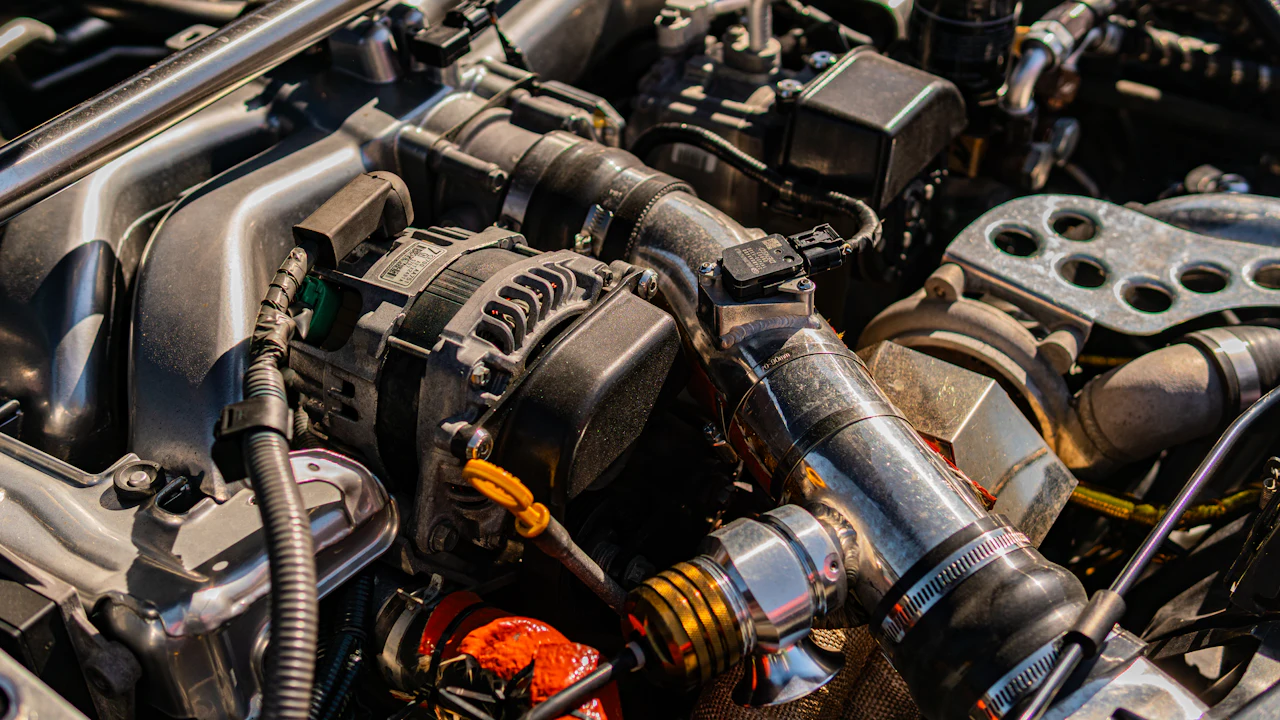 Complex car engine with various mechanical parts and hoses