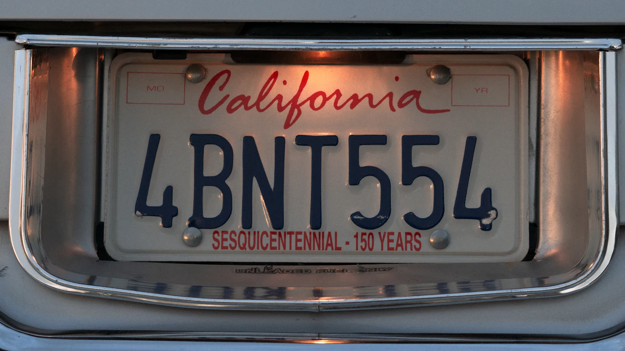 A California licence plate mounted in a chrome surround on a car bumper